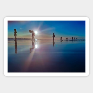 Copy of Silhouetted people in a row on a sand beach. Sticker